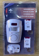 Home security motion sensor alarm kit with two remote controls and wall mount on wood surface