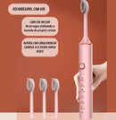 Pink electric toothbrush with USB charging, three extra brush heads, and cleaning modes.