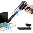 Mini handheld vacuum cleaner cleaning laptop keyboard with dust and debris removal